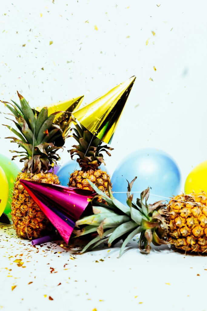 pexels-photo-1071883-1071883 Vibrant party scene with pineapples, balloons, and confetti, perfect for celebration themes.